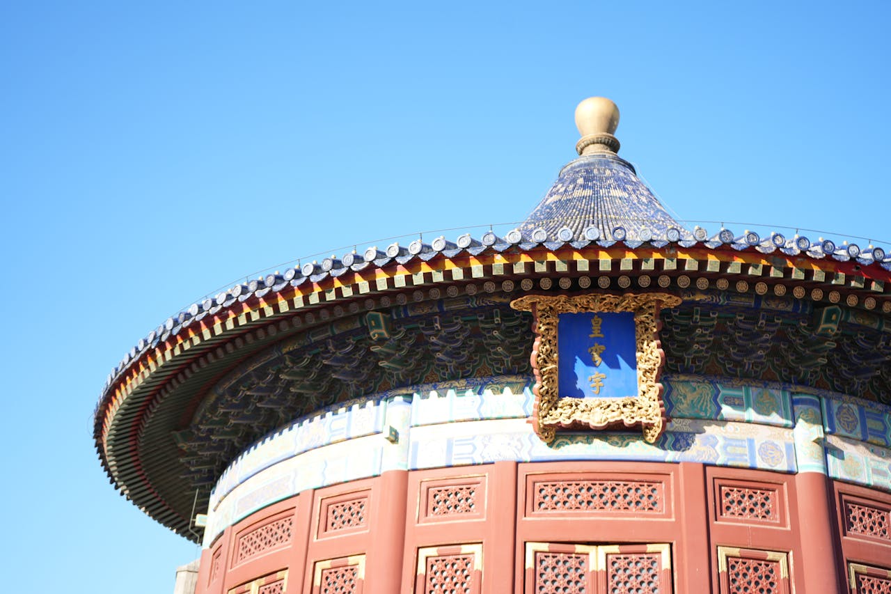 Close-up of ornate roof detail at the Temple of Heaven in Beijing, showcasing intricate design and vivid colors.